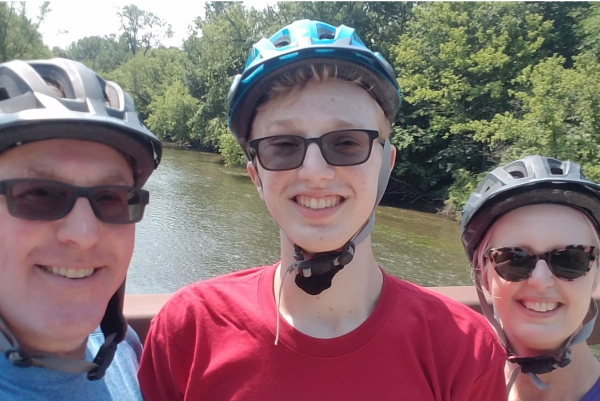 three family members wearing bike helmets and glasses