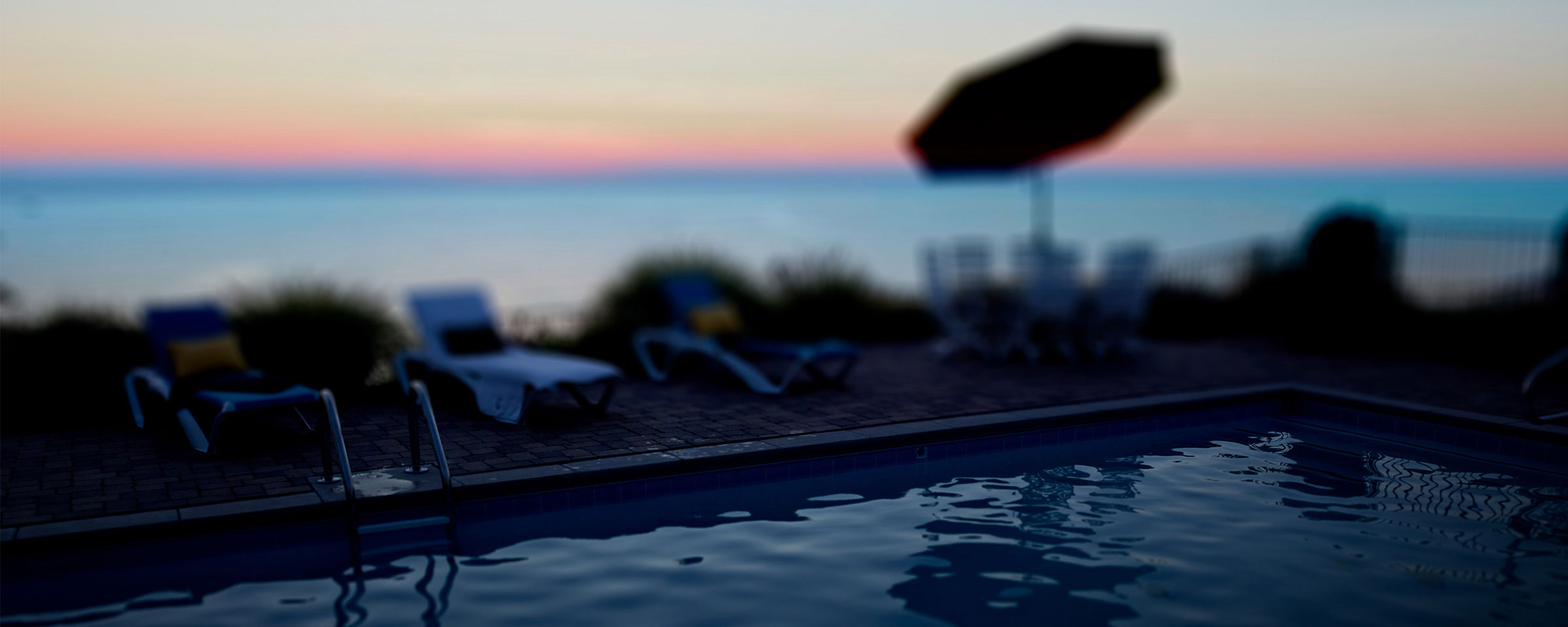 A tranquil poolside scene is shown as the background for the PoolIQ sales app created by Blue Flame Thinking for Pentair.